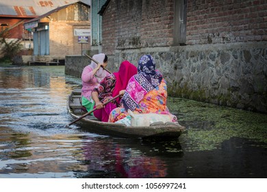 SRINAGAR, INDIA - October 2018: Woman in the boat on the water of Dal lake, Srinagar, Jammu and Kashmir, India