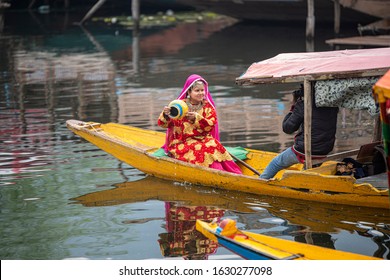 Srinagar, Jammu And Kashmir - April 16, 2019: Kashmiri Photographer Taking Pictures Pre Wedding Of  Young Woman In Indian Bridal Dresses On Wooden Boat At Dal Lake, Kashmir, India