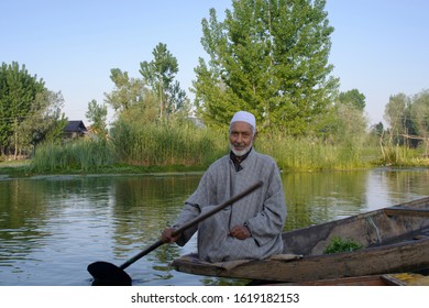 Srinagar, Jammu and Kashmir - April 28 2018: Salesman selling vegetables from their boat in the open floating market in dal lake gathered to post for pictures.