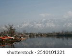 Srinagar, Jammu and Kashmir   India - December 17, 2019 : A view of the Dal lake, and the beautiful mountain range in the background in the city of Srinagar.