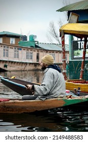 Srinagar, Jammu and Kashmir, India - March 1 2022: A portrait of a Kashmiri Shikara boat sailor Indian man on Dal Lake. The hands might be blurred due to motion.