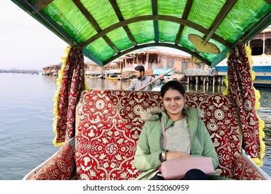Srinagar, Jammu and Kashmir, India - March 1 2022: A selective focus of a young Indian woman enjoying Shikara boat ride on Dal Lake, Srinagar, Jammu and Kashmir, India.