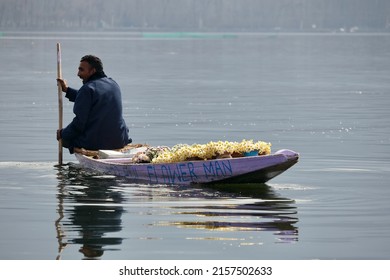 Srinagar, Jammu and Kashmir, India - March 1 2022: A portrait of a Kashmiri Shikara boat sailor and Flowers vendor Indian man on Dal Lake. The hands might be blurred due to motion.