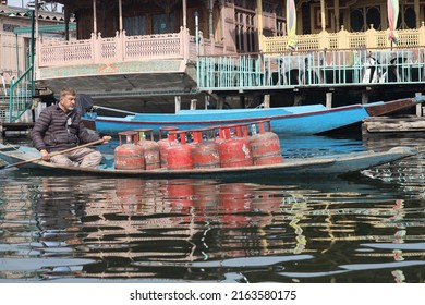 Srinagar, Jammu and Kashmir, India - March 1 2022: A portrait of a Kashmiri Shikara boat sailor and Gas Cylinder vendor Indian man on Dal Lake. The hands might be blurred due to motion.