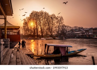 Srinagar, Kashmir, India - January 29, 2021 : Beautiful view of Dal Lake in the evening time, and the beautiful mountain range in the background in the city of Srinagar, Kashmir, India.