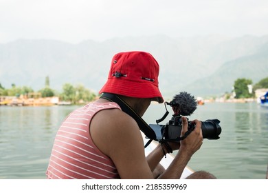 Srinagar, Kashmir, India - June 10 2022: A photographer get ready to take a picture at Dal Lake.