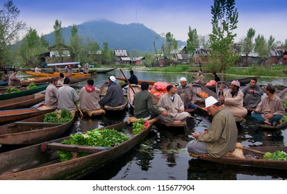 SRINAGAR,INDIA -APRIL 14: Lifestyle in Dal lake,Kashmiri men sell their vegetables at a floating market in the early hours before sunrise on April 14,2012 in Dal Lake, Srinagar,Jammu & Kashmir, India.