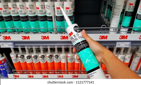 Sriracha, Chonburi THAILAND June 24, 2018: Man's Hands Are Holding Silicone Sealant Brand 3M In Hardware Stores.