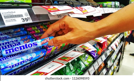 Sriracha, Chonburi THAILAND June 29, 2018: Man's Hands Are Buying Candy Brand Mentos In A Supermarket.