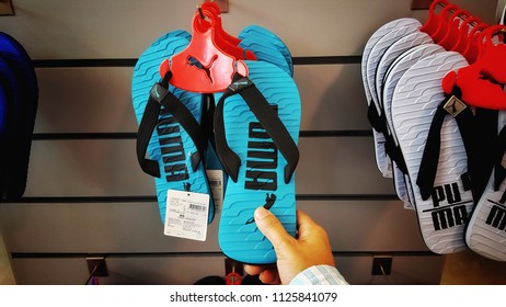 Sriracha, Chonburi THAILAND June 30, 2018: Woman's Hands Are Buying Sandals Brand PUMA On The Shelves. 