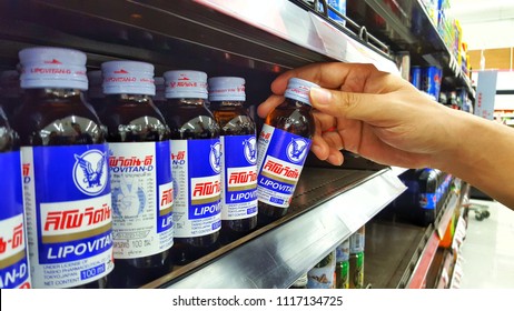 Sriracha, Chonburi THAILAND June 9, 2018: Man's Hands Are Holding Energy Drink Brand Lipo Vitan-D On A Shelf In A Supermarket.