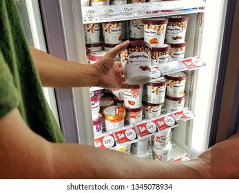 Sriracha, Chonburi THAILAND Mar 9, 2019: Man's Hand Is Holding Häagen-Dazs Ice Cream Cup From Supermarket Refrigerator.