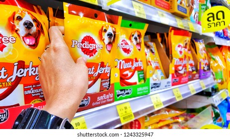 Sriracha, Chonburi THAILAND Nov  5, 2018: Woman's Hand Is Holding  Dog Food Bag Pedigree Brand From Supermarket Shelf.