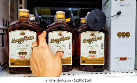 Sriracha, Chonburi THAILAND Oct  23, 2018: Man's Hand Is Holding  Thai Whisky Bottle Brand Sangsom From Supermarket Shelf.