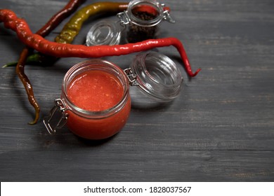 Sriracha - A Dish Of Thai Cuisine - Hot Pepper Sauce On A Dark Background. A Place For A Copy Of Space. Horizontal Orientation