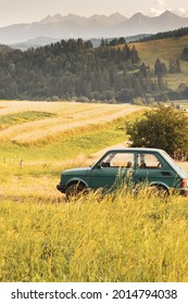 SROMOWCE WYZNE, POLAND - July 24, 2021: Fiat 126 on the field with Tatra Mountains in the background
