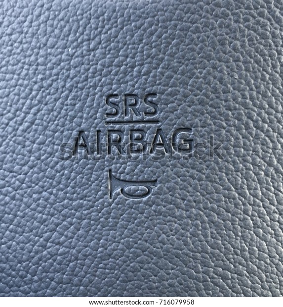 Srs airbag logo on leather texture of cars\
steering wheel.