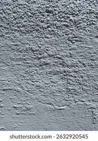 sstkBackgrounds Abstract. Grey, bumpy, uneven, painted wall. Sun creating shadows on the surface..jpg