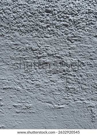 sstkBackgrounds Abstract. Grey, bumpy, uneven, painted wall. Sun creating shadows on the surface..jpg