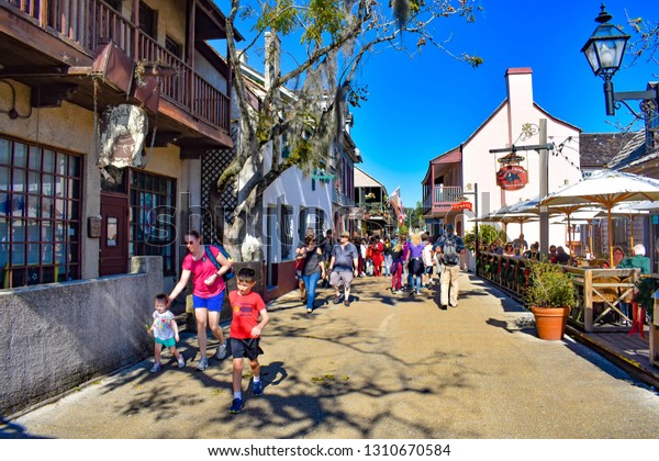 St. Augustine, Florida. January\
26 , 2019 . People enjoying colonial experience in St. George St.\
on blue sky background in Old Town at Florida\'s Historic\
Coast.
