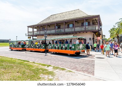 St. Augustine, USA - May 10, 2018: St George Street On Sunny Day In Downtown Old Town Florida City With Trolley Tour Tram Train And Many People