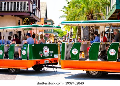 St. Augustine, USA - May 10, 2018: People riding at old town Florida Colonial quarter on tour guide bus trolley in historic city on summer sunny hot day at St George street