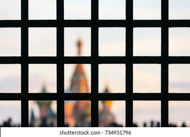 St. Basil's Cathedral on Red Square with a large number of people is hidden behind bars. Moscow behind bars, Russia. - Powered by Shutterstock