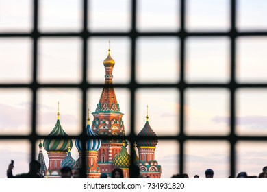 St. Basil's Cathedral on Red Square with a large number of people is hidden behind bars. Moscow behind bars, Russia. - Powered by Shutterstock