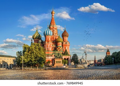 St. Basil's Cathedral On Red Square In The Kremlin In Moscow In The Light Of The Evening Sun And Clouds In The Blue Sky