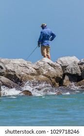 St. George Island, FL - A Fisherman On The Jetty Rocks.