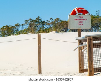 St. George Island, FL: White Sand With Contrasting Pine Trees And Sky In Background. Emergency Flotation Buoy Is Ready To Be Used.