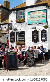 St Ives, Cornwall, England, UK, Britain - September 2010:
The Sloop Inn Traditional 14th Century Pub Busy With Holidaymakers Sitting Outside