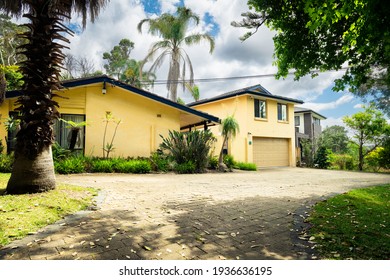 St Ives, Sydney, Australia - Oct 30 2020: The Front Of Suburban Home  Residence With Yellow Paint Work, Garden Looking Up The Driveway