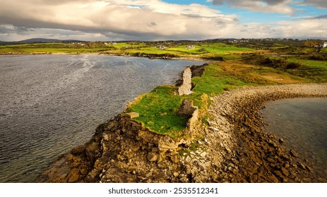 St John s Point in Donegal at the west coast of Ireland - A beautifully serene coastal landscape featuring a historic ruin, calm waters, and lush greenery all around it - Powered by Shutterstock