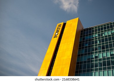 St. John's, Newfoundland, Canada -June 2022: The Upward View Of The Fortis Building. The Exterior Wall Of The Tall Building With Wood Style Metal Panels, Glass Windows With Shades, And A Sign, Fortis.