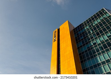 St. John's, Newfoundland, Canada -June 2022: The Upward View Of The Fortis Building. The Exterior Wall Of The Tall Building With Wood Style Metal Panels, Glass Windows With Shades, And A Sign, Fortis.