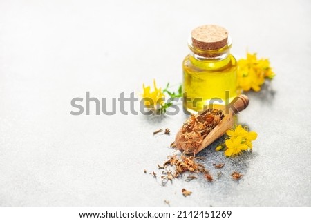 St. John's wort extract oil in a bottle on a gray background. Vegan food. Natural cosmetics