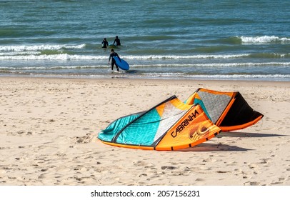 St Joseph MI USA, Sept 26, 2021; People With Surf Boards Head Into Lake Michigan, While A Kite Rests On The Beach Waiting For More Wind.