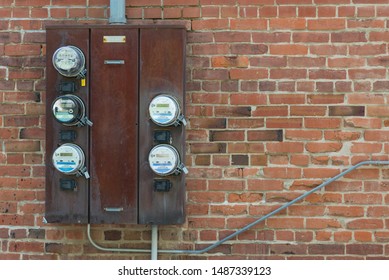 St. Joseph, Missouri / United States Of America - August 23rd. 2019 : A Group Of Electric Meters Attached To A Brick Building.  Multiple Meters On One Box.