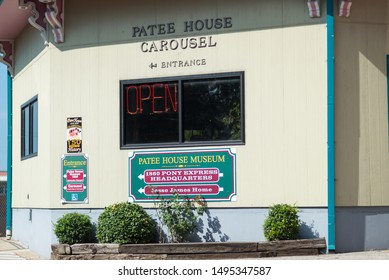 St. Joseph, Missouri / United States of America - August 29th, 2019 : Patee House Carousel entrance signs on the side of the building.  Jesse James home and pony express headquarters sign.