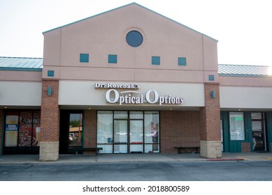 St. Joseph, MO United States Of America - August 2nd, 2021 : Dr. Rosenak's Optical Options, Eyeglass Store In Strip Mall, Main Entrance With Large Sign Above Doors.  Small Local Business, No People.