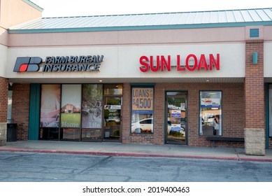 St. Joseph, MO United States Of America - August 2nd, 2021 : Sun Loan And Farm Bureau Insurance Storefronts With Signage Above.  Strip Mall Retail Locations.