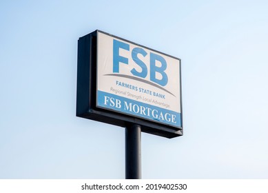 St. Joseph, MO United States Of America - August 2nd, 2021 : Farmers State Bank Large Sign Outside Of Branch Location.  FSB Mortgage Company, Isolated Sign With Blue Sky Background.