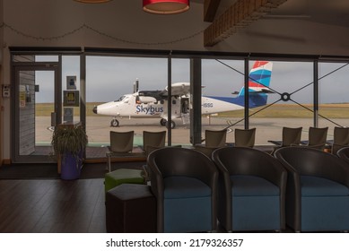  St Just, Cornwall, England. UK. Empty Departure Lounge And A Delayed Aircraft Visiable Through Window Of A Small Airport Terminal. Boarding Gate.