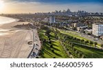 St Kilda, Victoria, Australia - May 15, 2024: Aerial view of St Kilda West Beach, Catani Gardens and the Melbourne city skyline.
