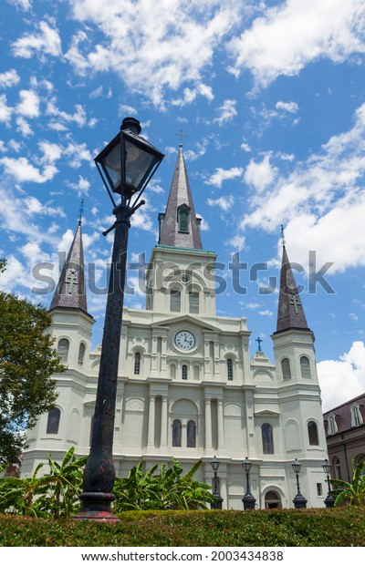 St. Louis Cathedral, as seen from Jackson Square\
in the French Quarter of New Orleans, Louisiana, USA during a\
summer day with clouds in the\
sky.