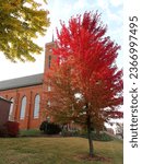 St. Louis Catholic Church, Louisville, Ohio, Red Brick Church with Spire in October with Green, Yellow, Orange, and Red Maple Leaves, Autumn Leaves