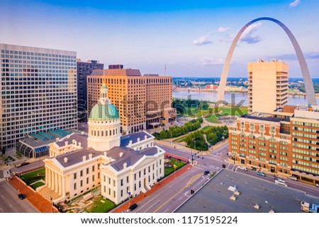 St. Louis, Missouri, USA downtown cityscape with the arch and courthouse at dusk.