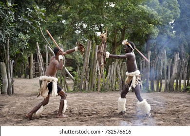 St. Lucia- South Africa - June 25, 2017: Zulu warrior in traditional dress with ighting spear in Khula Zulu Village in South Africa