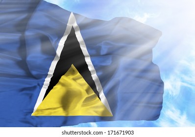St Lucia waving flag against blue sky with sunrays